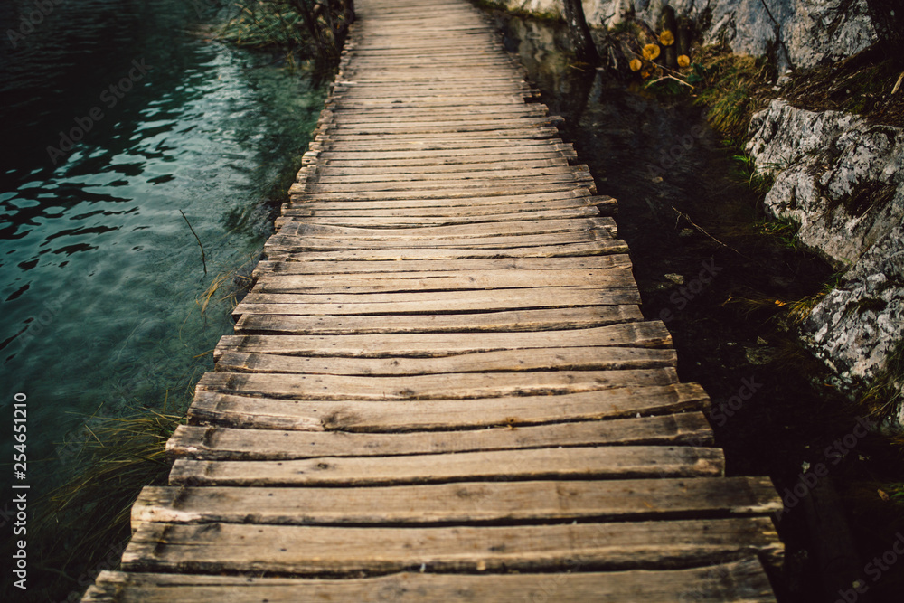 Wooden pathway in  Plitvice National Park, Croatia, Europe. Popular nature tourist attraction Plitvice lakes.