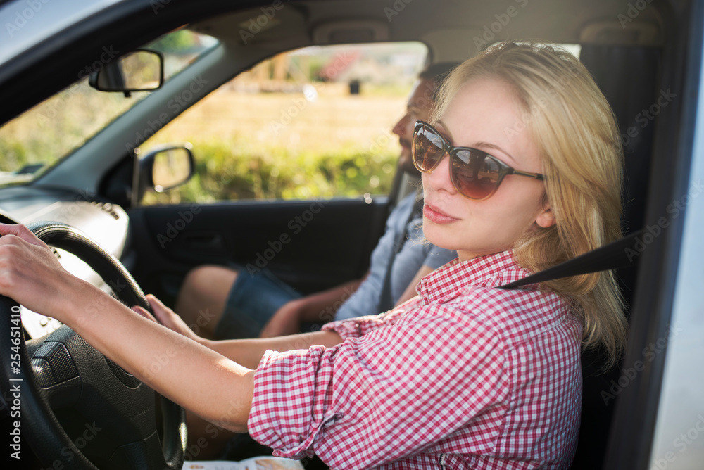 Happy couple traveling by car in nature. Carefree friend travelers on countryside roadtrip journey. Happy couple traveling by car in nature. Carefree friend travelers on countryside roadtrip journey.