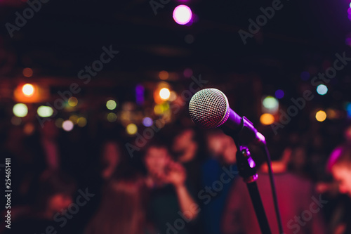 Microphone with blurred colorful bright light in dark night background, soft focus image for business technology communication concepts. photo