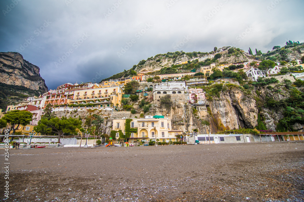Panoramic view of the beach with colorful buildings of Positano, Italy.