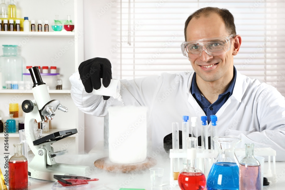 A young scientist makes experiments A young scientist makes experiments