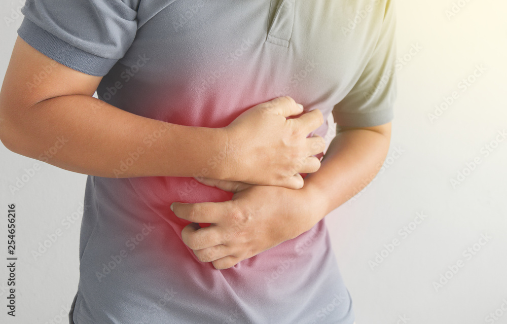 asian man suffering from stomachache. Concept with Health care And Medicine. asian man suffering from stomachache. Concept with Health care And Medicine.