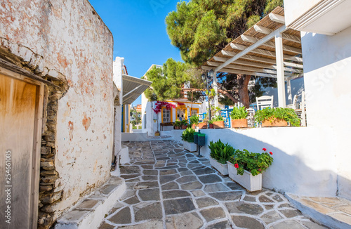 Fototapeta Naklejka Na Ścianę i Meble -  Small narrow street of Greek village of Lefkes with white houses, Paros island