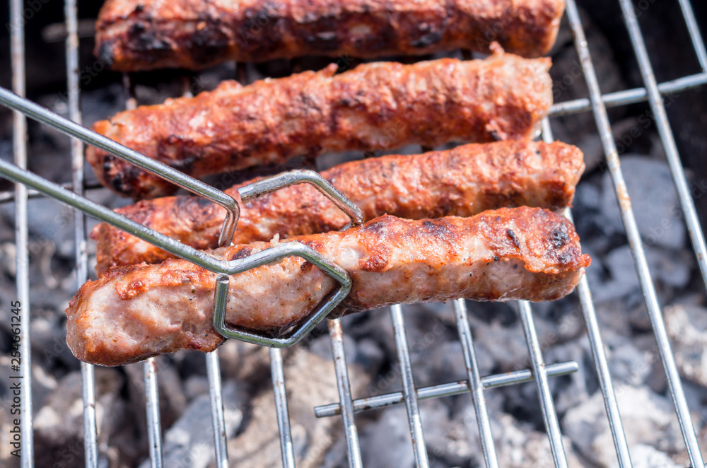 Grilling. Cooking barbecue with charcoal in the garden. T