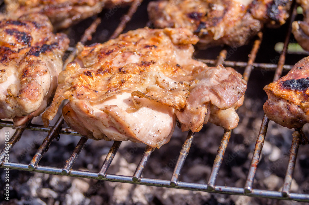 Chicken steak on the grill. Cooking chicken on the barbeque with charcoal in garden.