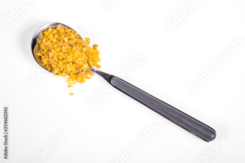 coucous in metallic spoon photo