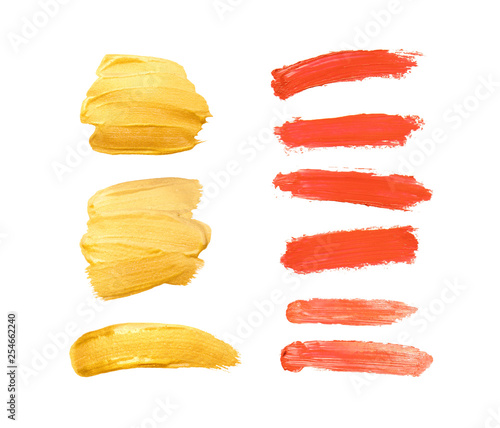 Set of gold, living coral and red strokes isolated on white background. Lipstick bullet smudged. Beautiful textured brush strokes and hearts. Living coral - color of the year 2019.