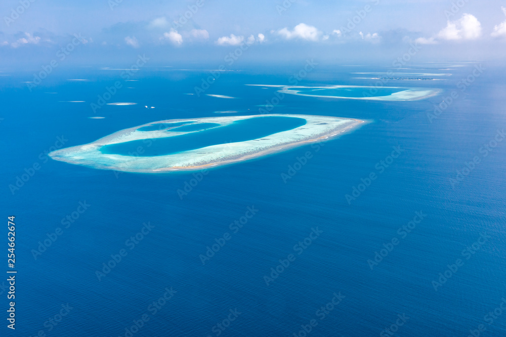 Naklejka premium Aerial view of Maldives atolls is the world top beauty. Maldives tourism. Exotic aerial landscape in Maldives islands