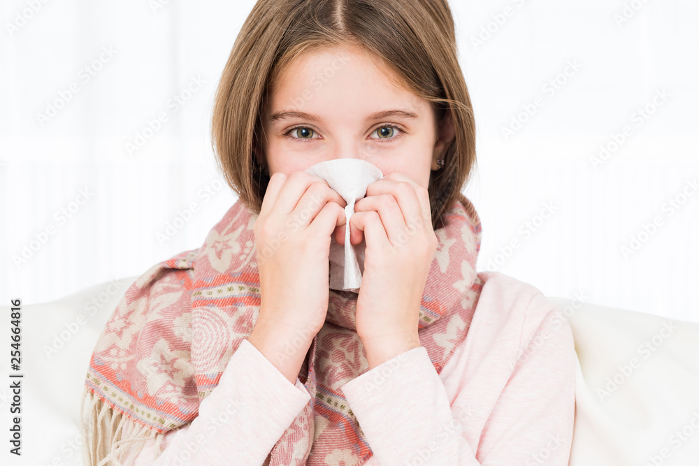 Little ill girl holding napkin to sneeze Little ill girl holding napkin to sneeze