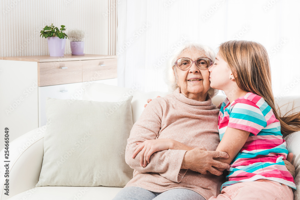 Granddaughter lovely kissing and hugging grandmother Granddaughter lovely kissing and hugging grandmother