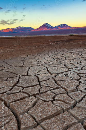 Cracked earth and Licancabur volcano at the Atacama Desert.