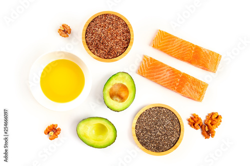 Ingredients of a healthy omega-3 diet. Raw salmon, avocado, nuts, chia and flax seeds, shot from the top on a white background