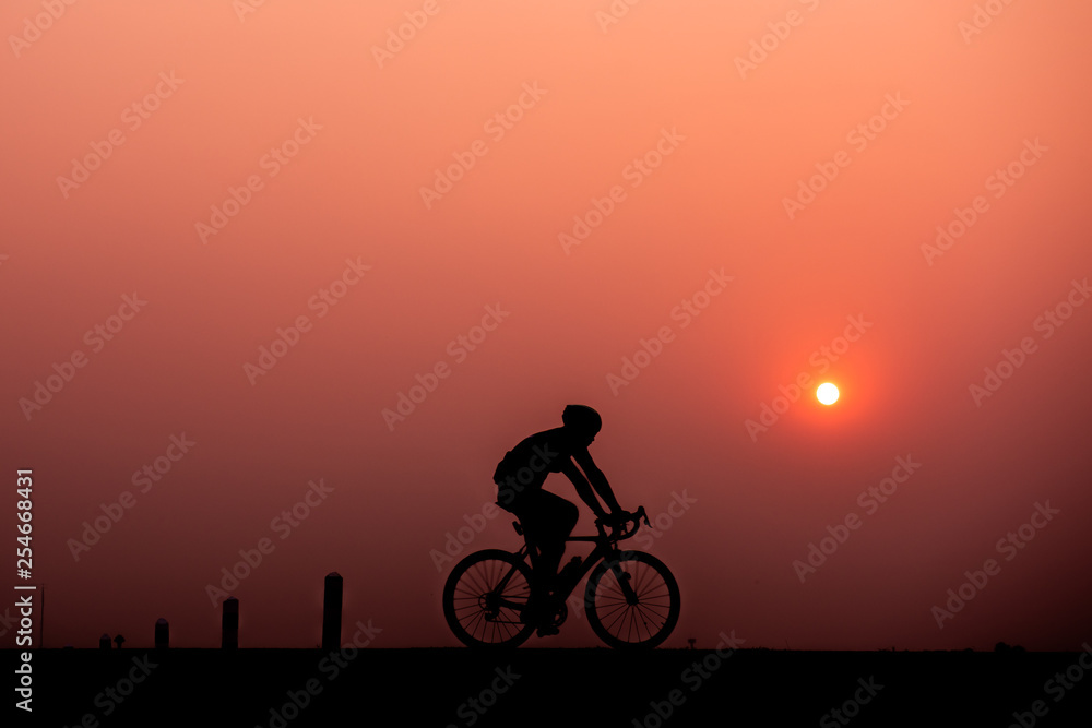 ride bicycle with sunset background.
