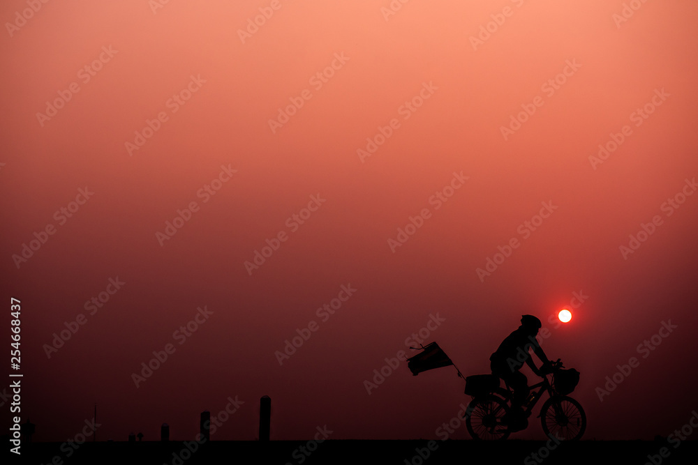 Obraz premium ride bicycle with sunset background.