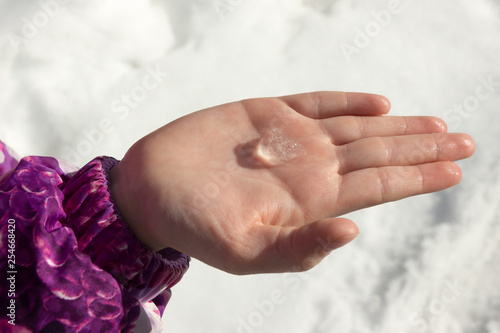 child holds in the palm of his hand a piece of ice in winter isolated on a white backgroundthe child holds in the palm of his hand a piece of ice in winter isolated on a white photo