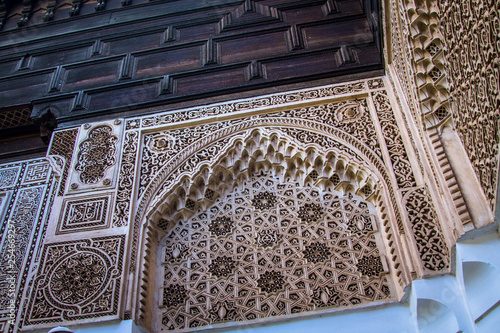 Beautiful complex exquisite carving on the plastered white walls of the Bahia Palace in the southeastern part of the medina of Marrakesh. Morocco Africa