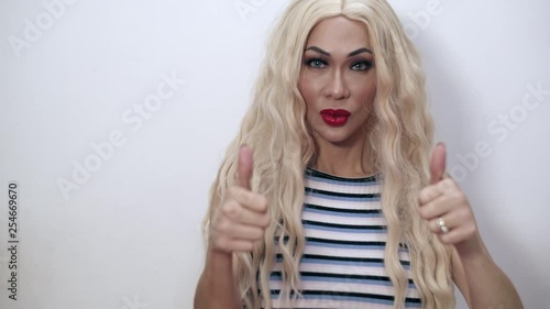 Shot of a beautiful transgender woman doing a thumbs up symbol hand gesture