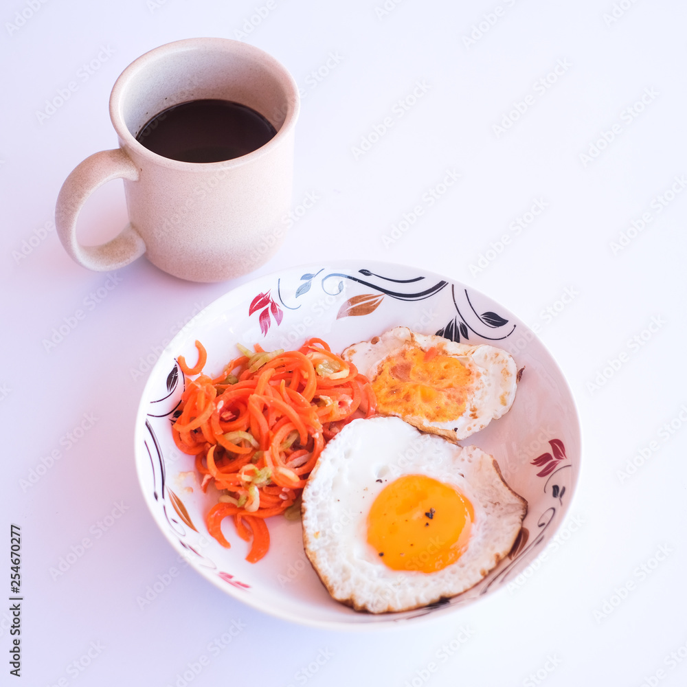 A set of healthy food, fried egg, minced carrot and a blackberry juice. A set of healthy food, fried egg, minced carrot and a blackberry juice.