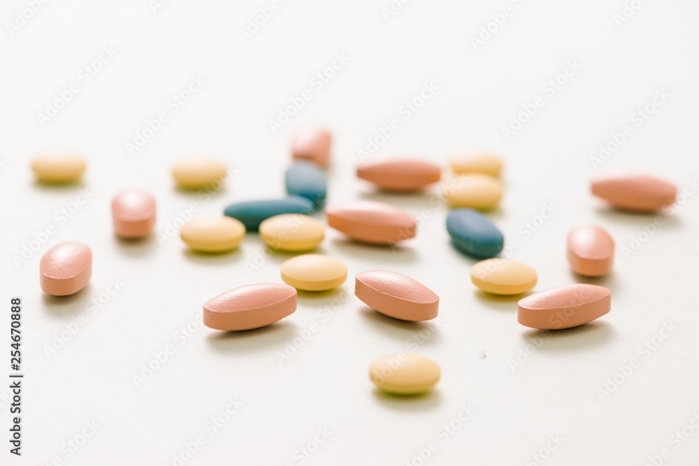 Tablets and capsules over white background