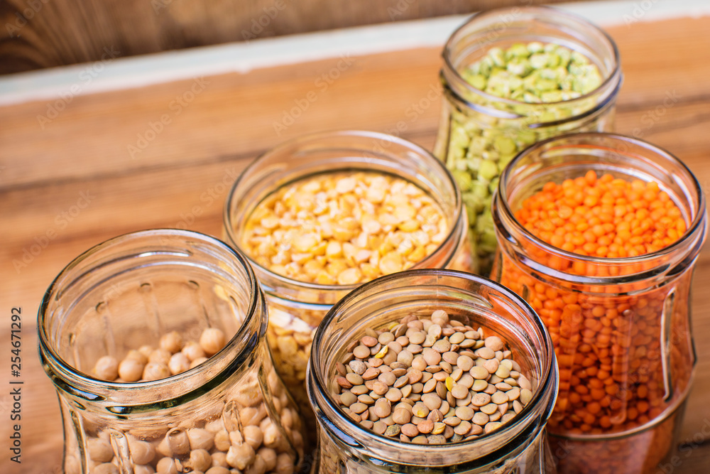 Healthy food, diet, nutrition concept, vegan protein and source of carbohydrates. Assortment of colorful raw legumes on wooden table Healthy food, diet, nutrition concept, vegan protein and source of carbohydrates. Assortment of colorful raw legumes on wooden table