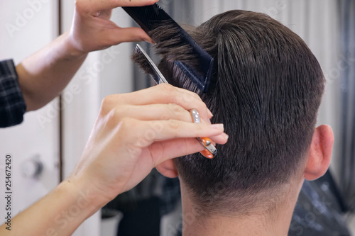 female barber haircut doing male hair style, close up