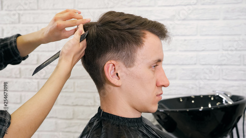 Female hairdresser haircut doing male hair style.