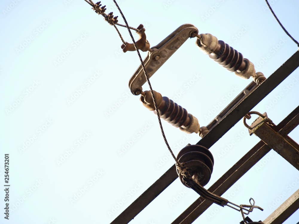Old power transmission lines, closeup, clear sky, energy concept Old power transmission lines, closeup, clear sky, energy concept