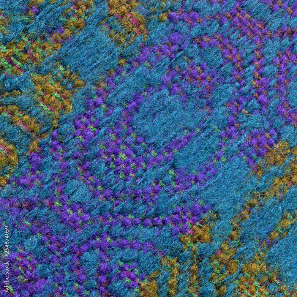 Detail of handwoven woolen fabric in purple, yellow and blue