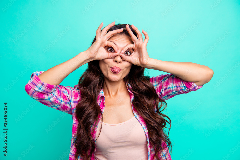 Close-up portrait of her she lovely attractive cheerful comic crazy wavy-haired lady wearing checked shirt showing binoculars having fun isolated over turquoise bright vivid shine background Close-up portrait of her she lovely attractive cheerful comic crazy wavy-haired lady wearing checked shirt showing binoculars having fun isolated over turquoise bright vivid shine background