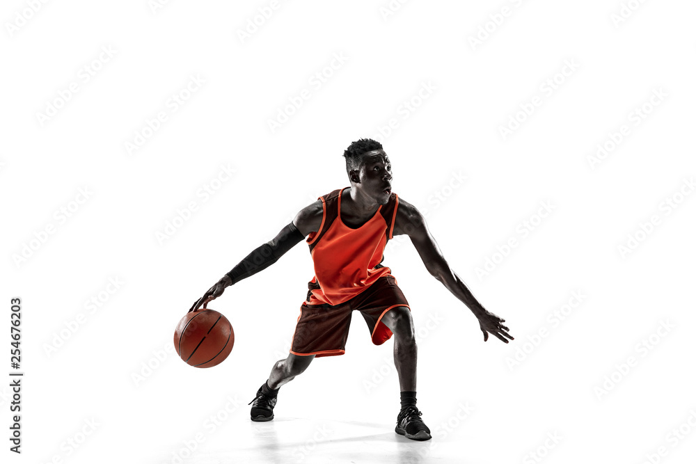 Naklejka premium Full length portrait of a basketball player with a ball isolated on white studio background. advertising concept. Fit african anerican athlete with ball. Motion, activity, movement concepts.