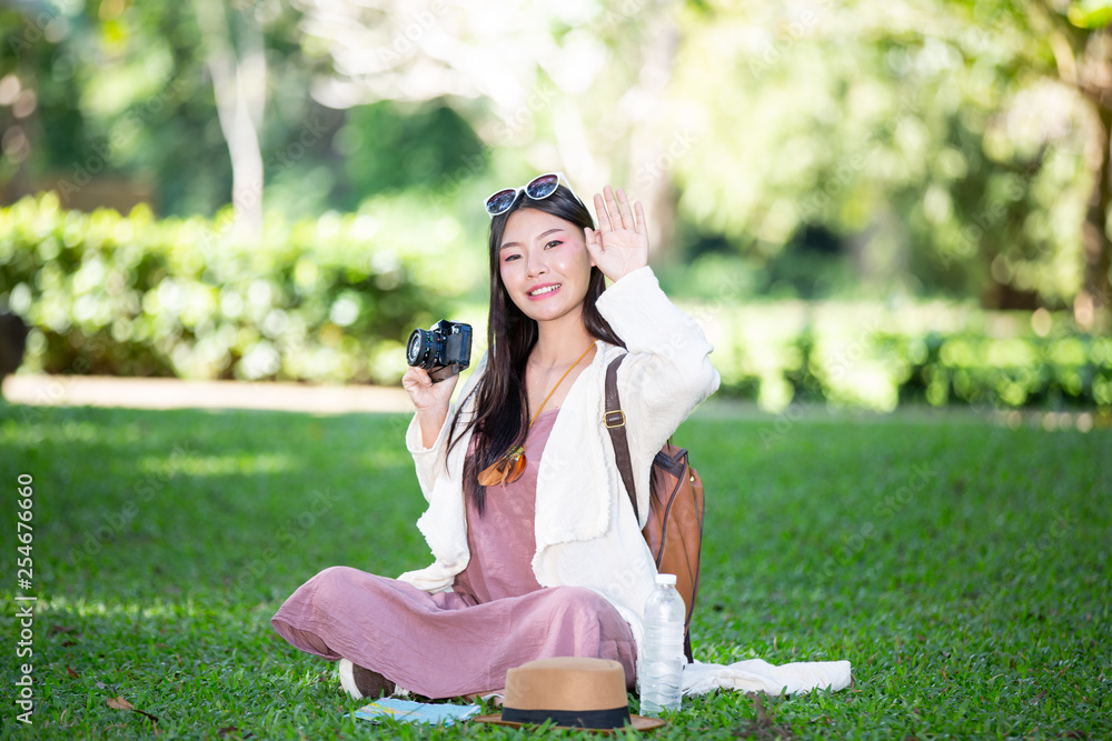 Female tourists who are taking photos of the atmosphere and smile happily. Female tourists who are taking photos of the atmosphere and smile happily.