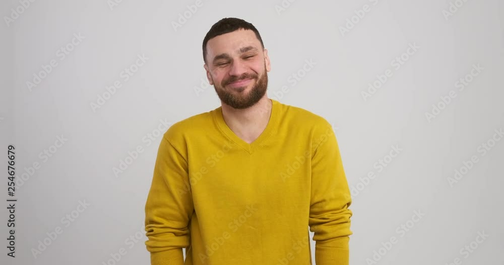 Young man laughing out loud on studio background Young man laughing out loud on studio background
