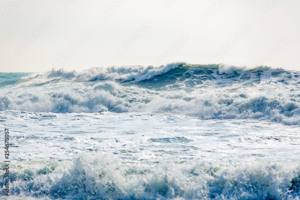 Strong and dangerous storm in the Black sea. Beautiful and large storm surge in the Bay of Gelendzhik in Gelendzhik. sea foam, wave crests, clear green water. Strong and dangerous storm in the Black sea. Beautiful and large storm surge in the Bay of Gelendzhik in Gelendzhik. sea foam, wave crests, clear green water.