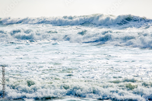 Strong and dangerous storm in the Black sea. Beautiful and large storm surge in the Bay of Gelendzhik in Gelendzhik. sea foam, wave crests, clear green water. 