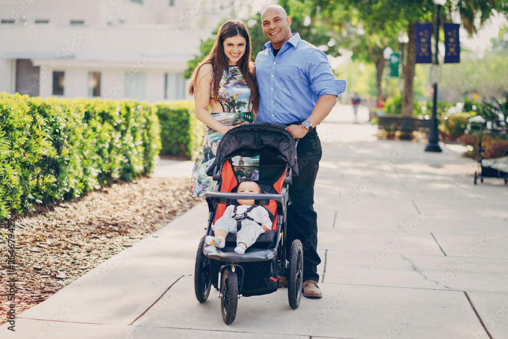 mom and dad a wonderful little son walking in summer sunny city mom and dad a wonderful little son walking in summer sunny city