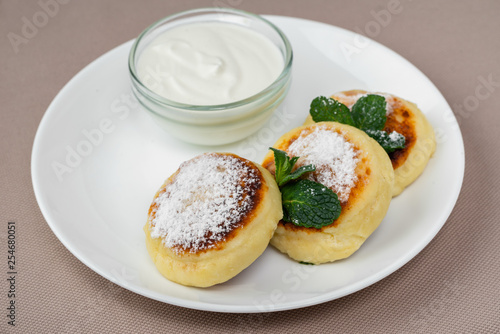 pancakes with powdered sugar and sour cream