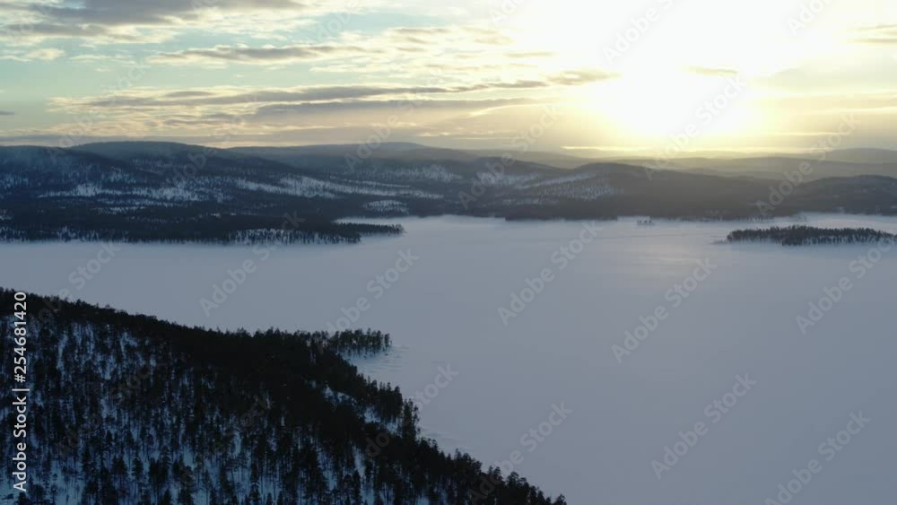 Drone flies at sunset over the beautiful ice landscape of the frozen Lake Inari in Finland, Sellaniemi, Mahlatti, Veskoniemi Drone flies at sunset over the beautiful ice landscape of the frozen Lake Inari in Finland, Sellaniemi, Mahlatti, Veskoniemi