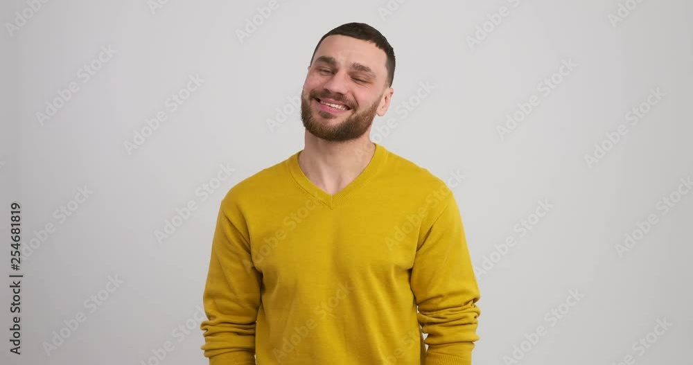 Handsome young man smiling in studio Handsome young man smiling in studio