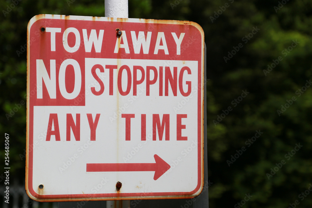 Vehicles illegally parked in the area will be removed by a tow truck labled Vehicles illegally parked in the area will be removed by a tow truck labled