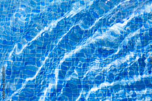 water ripples in swimming pool, blue background