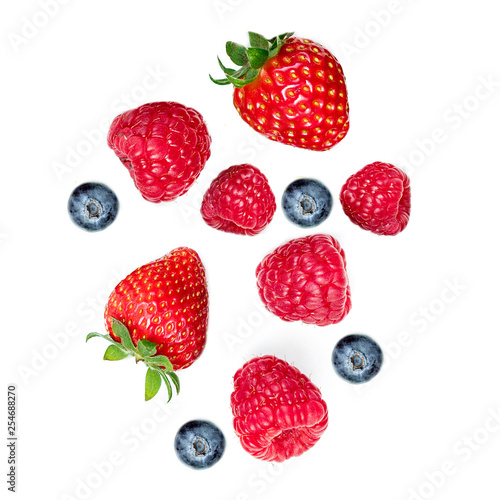 Mixed flying berries. Strawberry, Raspberry, Blueberries and Mint leaf isolated on white background, top view, flat lay.