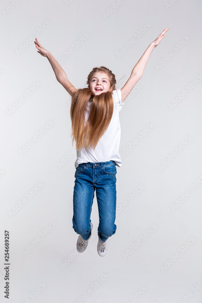 Playful happy blonde girl highly jumping with pulled hands Playful happy blonde girl highly jumping with pulled hands