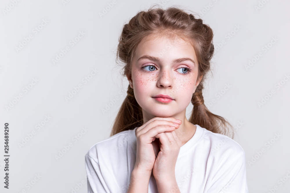 Thoughtful little lady with bright freckles looking aside Thoughtful little lady with bright freckles looking aside