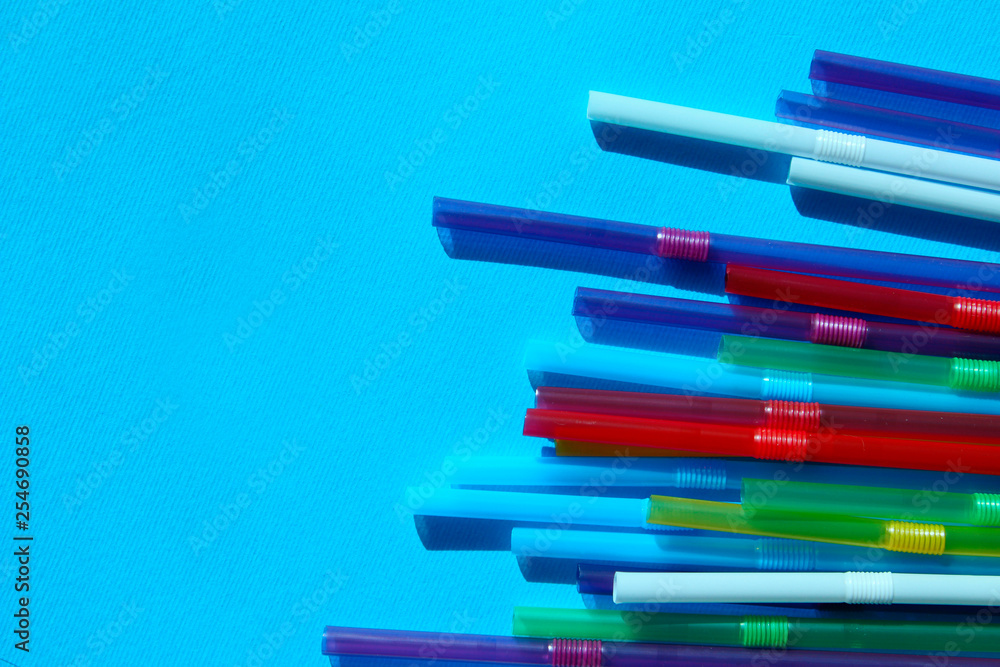 Colorful Plastic Cocktail Tubes Over Blue Background. Abstract Colorful Diagonal Lines. Colorful Background Textures.