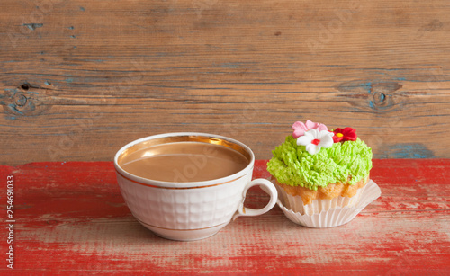flower spring cupcake  with hot coffee cup on wooden table © vadim yerofeyev
