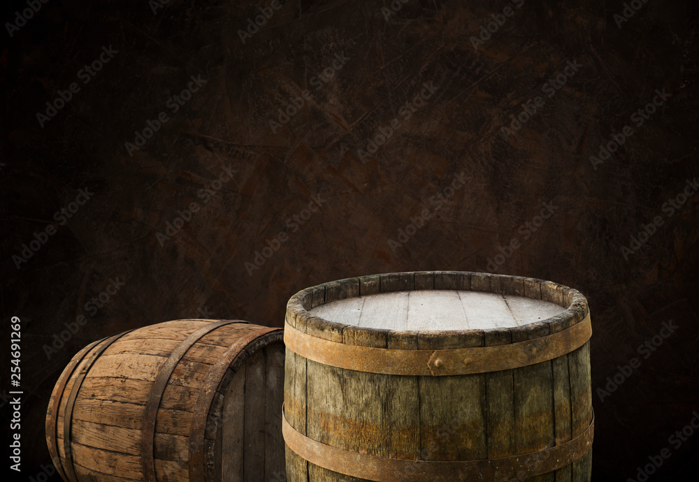 Oktoberfest beer barrel and beer glasses with wheat and hops on wooden table Oktoberfest beer barrel and beer glasses with wheat and hops on wooden table