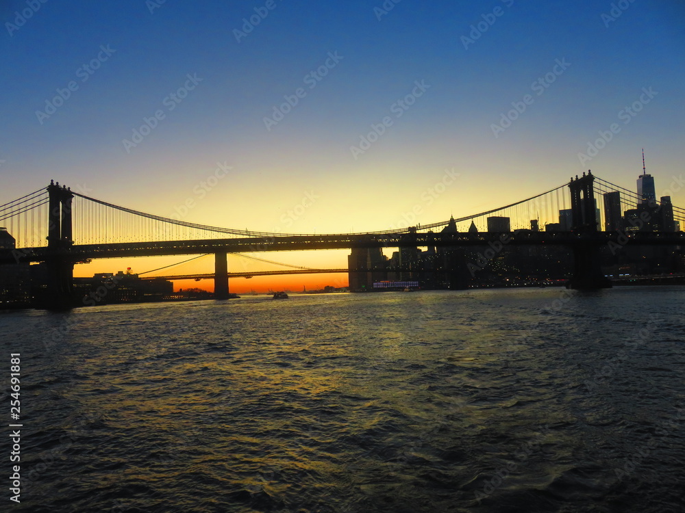 sunset at manhatten bridge with brooklyn bridge in background