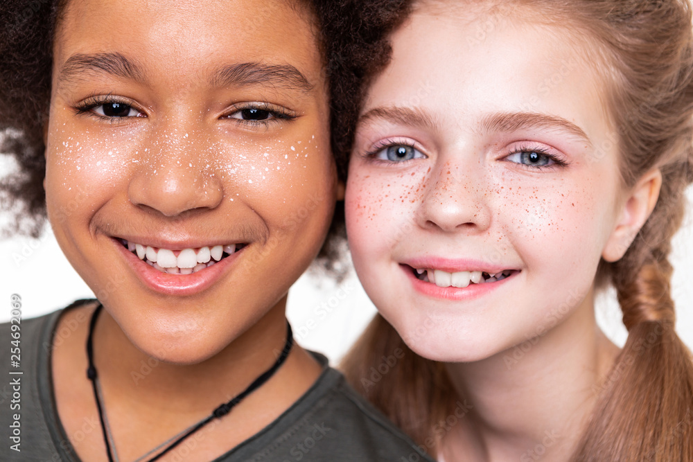 Pleasant good-looking kids displaying their strong white teeth Pleasant good-looking kids displaying their strong white teeth