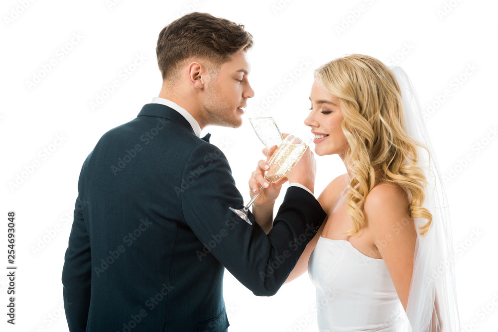 happy bride and groom drinking champagne isolated on white happy bride and groom drinking champagne isolated on white