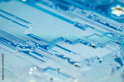 Lines of conductors on a blue printed circuit Board close-up